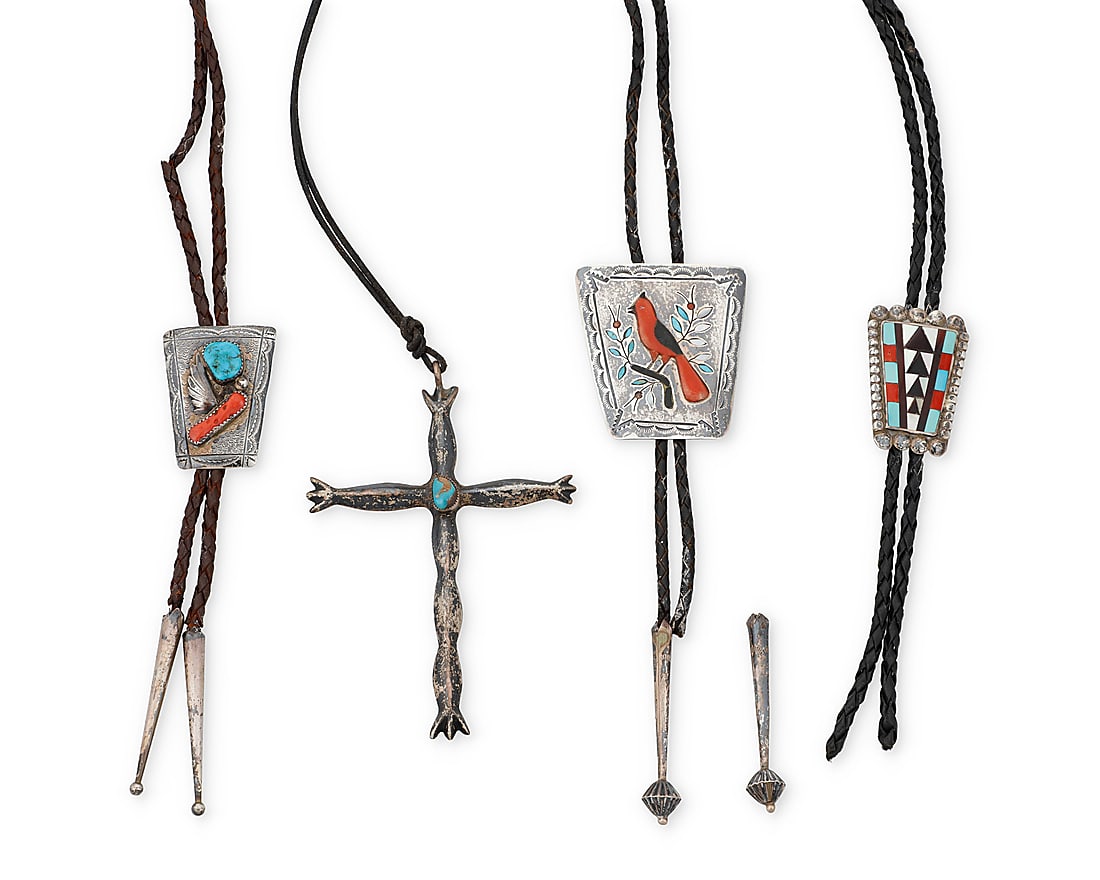 A group of Southwest silver jewelry: A group of Southwest silver jewelry Mid/late 20th century Variously marked for maker or for sterling Four works comprising a large cast sterling silver cross pendant with set turquoise, on a leather c