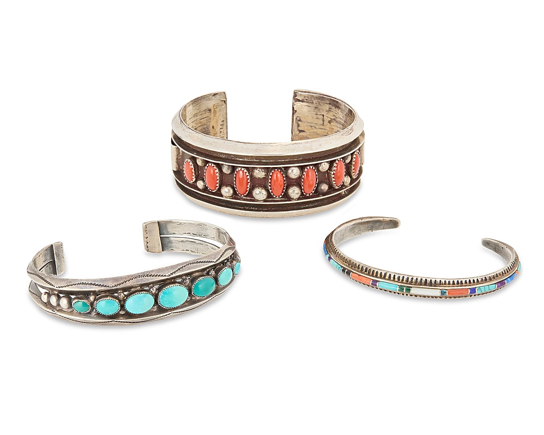 A group of Southwest sterling silver and set stone cuff bracelets: A group of Southwest sterling silver and set stone cuff bracelets Three works: Lilly Tom (b. 20th century, Dine) Late 20th century With incised signature; further stamped: BGM [for BG Mudd Co] / Sterl