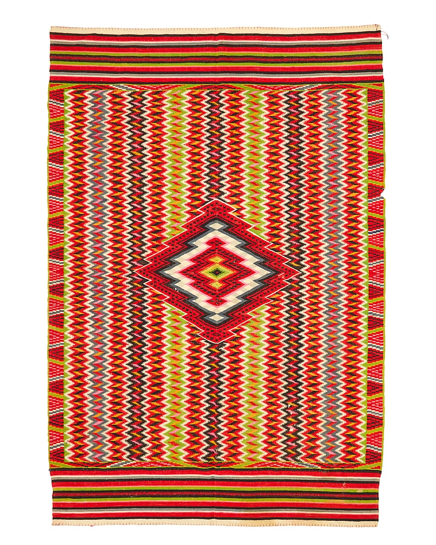 A Mexican Aggregate Period sarape: A Mexican Aggregate Period sarape Late 19th century Woven with wool weft on a cotton warp, with multicolored vertical serrated columns and a concentric-style diamond to center, with multicolored strip