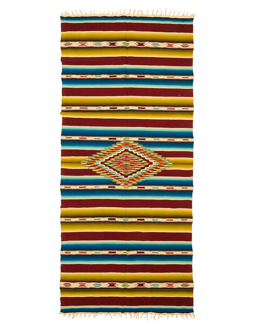 A Mexican Rainbow Saltillo sarape: A Mexican Rainbow Saltillo sarape Circa 1930s Finely woven in green, blue, brown and cream wool and silk with an elaborate central serrated concentric diamond with silver metal thread accents, multipl