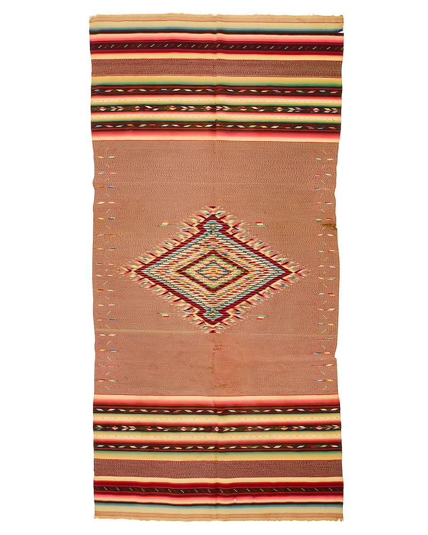 A Mexican Saltillo sarape: A Mexican Saltillo sarape Circa 1880 Finely woven in multicolored wool with an elaborate aggregate-style central serrated diamond with silver metal thread accents, Mexican flag motifs, and with multip