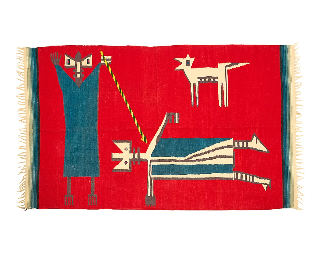 A Mexican pictorial sarape: A Mexican pictorial sarape Circa 1930 Depicting a standing god-like figure smiting a second figure, while a coyote animal looks on, the textile woven in red, blue, grey, cream and multicolored wool, w