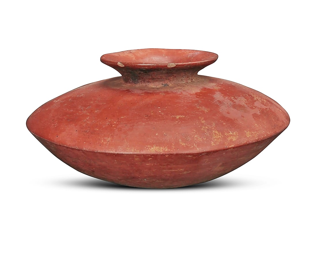A Pre-Columbian Colima redware pottery olla: A Pre-Columbian Colima redware pottery olla Circa 300-600 CE or later; Mexico Of flattened form with a broad shoulder and a short, flared neck 6.25" H x 12.5" Dia.
