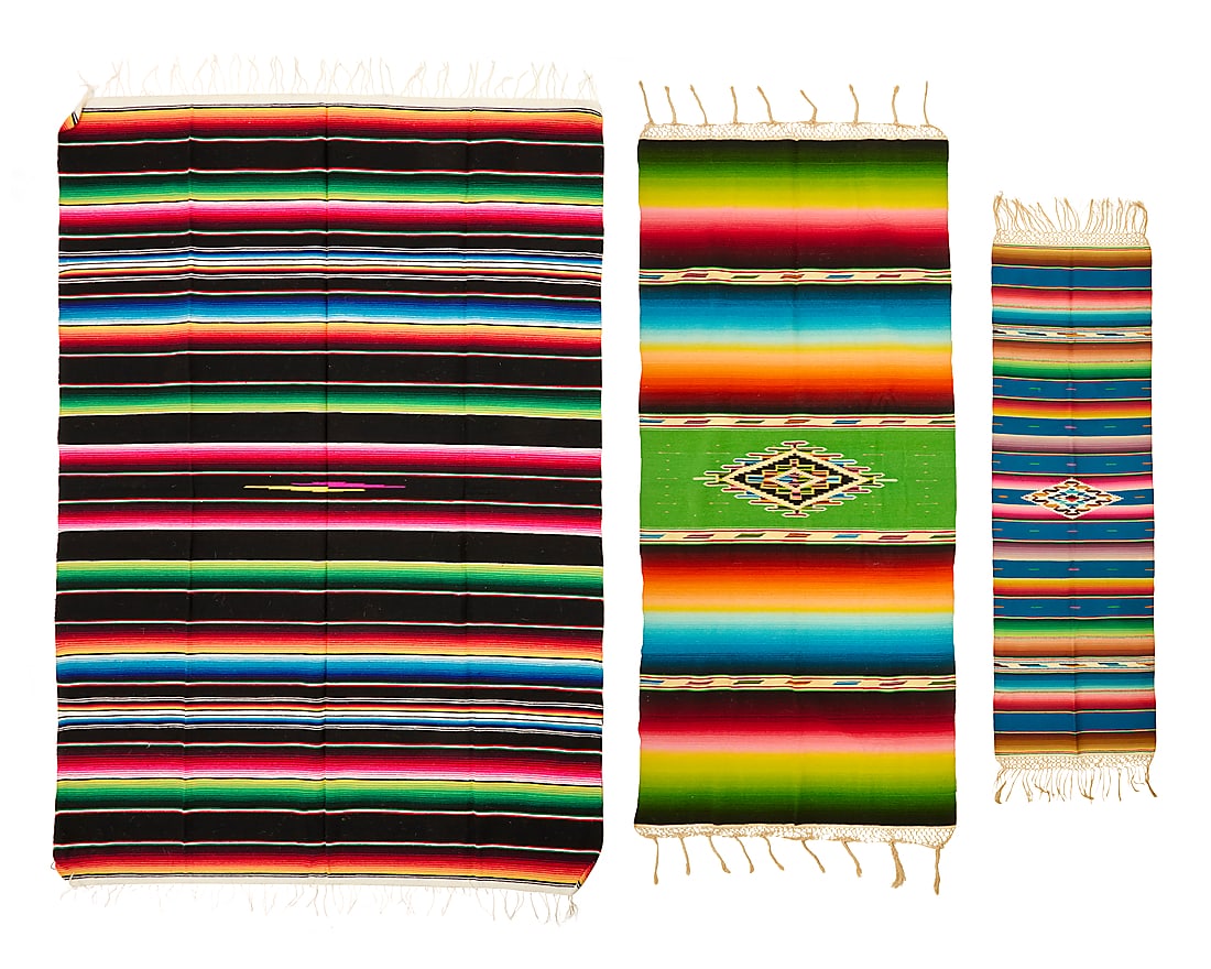 Three Mexican sarapes: Three Mexican sarapes Mid/late 20th century Comprising two sarapes finely woven in multicolored wool, each with a central serrated diamond amid multiple ombre shaded colored bands, with elaborate