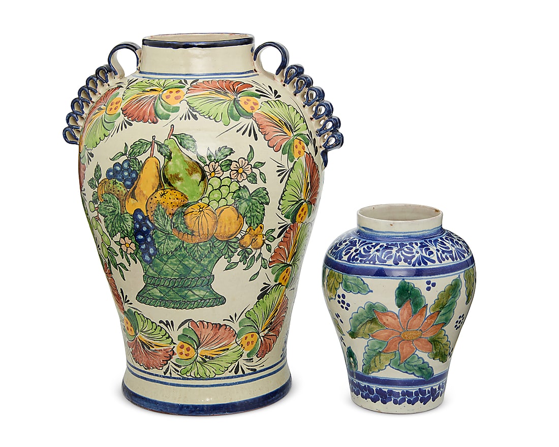 Two Mexican Talavera pottery jars: Two Mexican Talavera pottery jars 20th century; Puebla, Mexico Each unmarked Comprising a large baluster-form jar with opposed scrunched ribbon handles, one side featuring a painted polychrome basket 