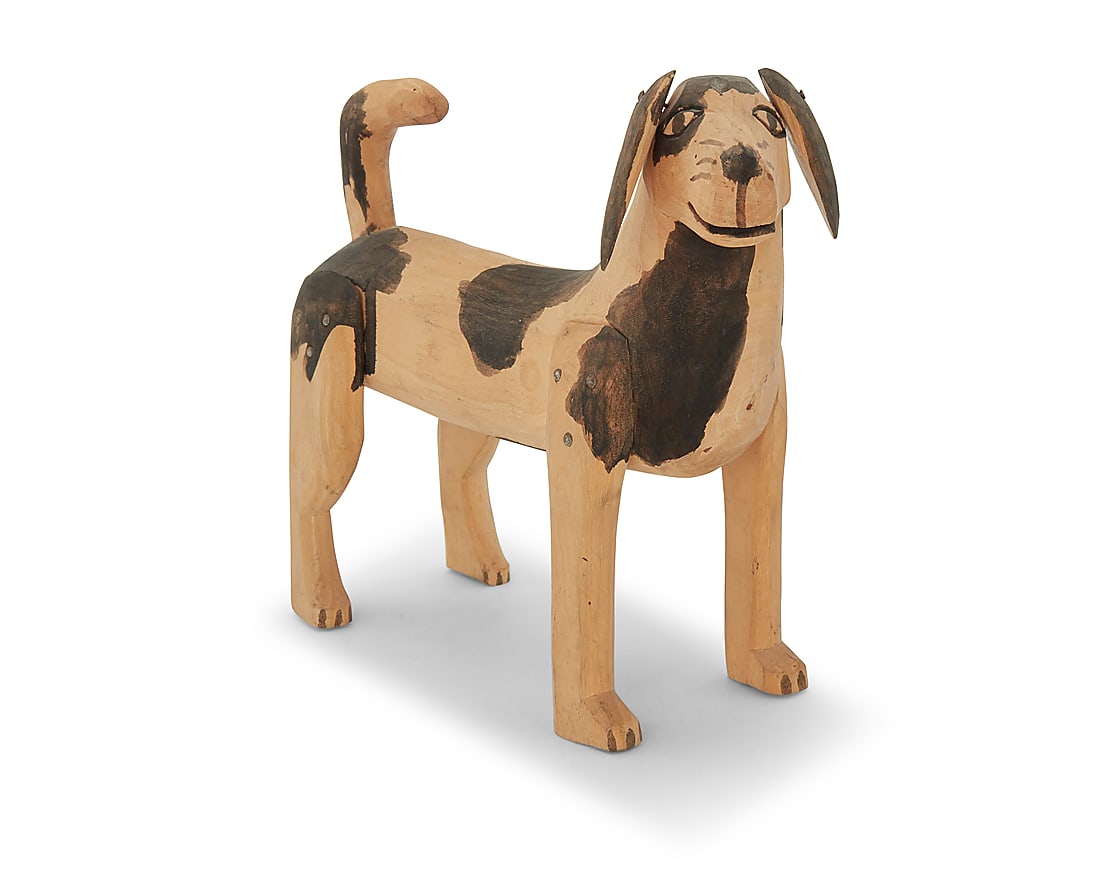 Attributed to Manuel Jimenez Ramirez (1919-2005, Mexican), A polychrome carved copal wood dog (1 of 3)