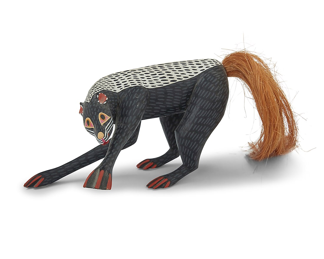 Manuel Jimenez Ramirez (1919-2005, Mexican) & Sons, A polychrome carved copal wood skunk alebrije,: Manuel Jimenez Ramirez (1919-2005, Mexican) & Sons A polychrome carved copal wood skunk alebrije, late 20th century; Oaxaca, Mexico Signed: AUTOR / MANUEL JIMENEZ / ANGELICO JIMENEZ / ISAIAS JIMENEZ C