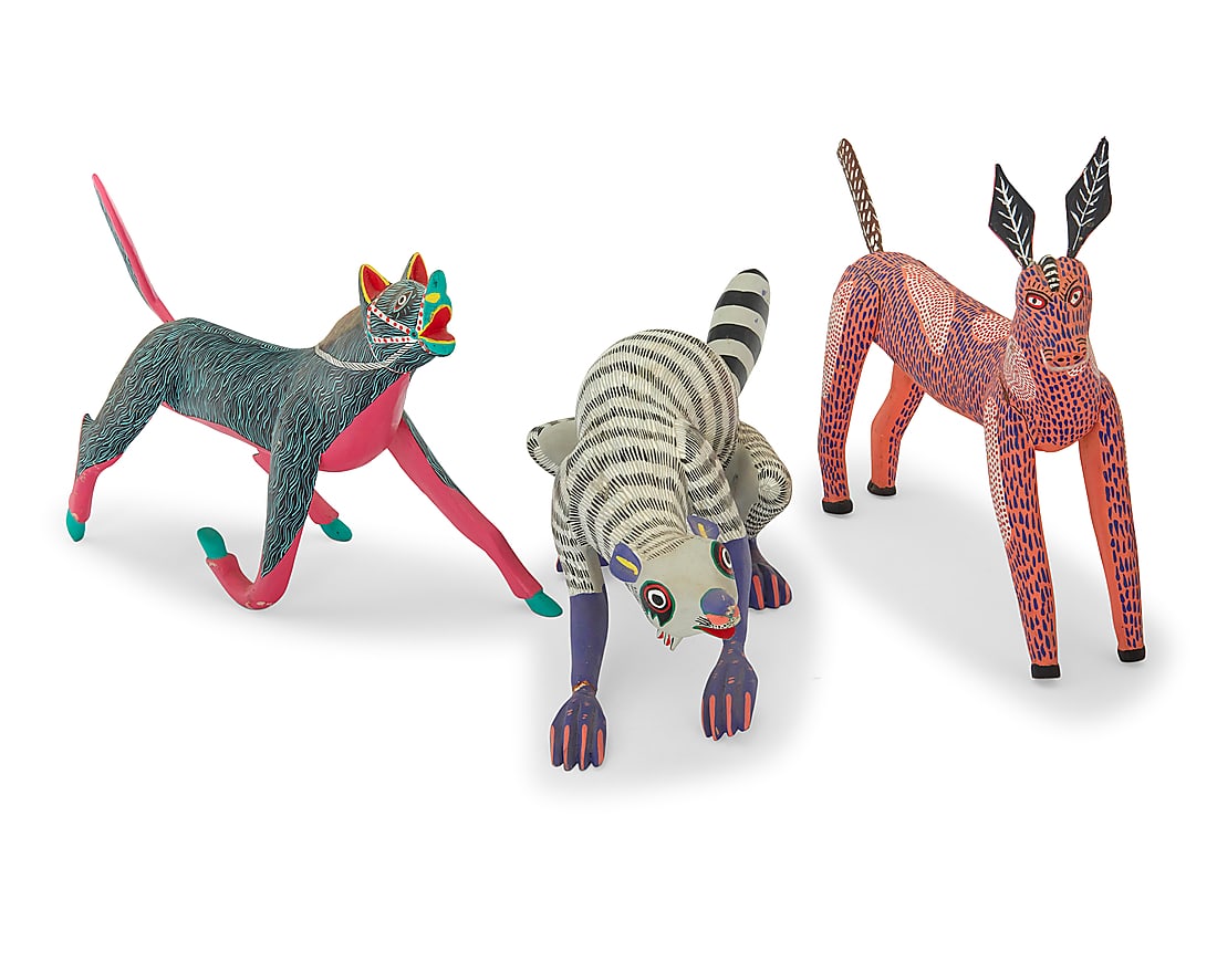 Three Mexican polychrome wood alebrijes: Three Mexican polychrome wood alebrijes Late 20th/early 21st century; Oaxaca, Mexico The pink signed and inscribed: Rodrigo. M. O; the skunk: JOSE LUIS SANTIAGO / ARRAZOLA; the green: Alfonso Fabian M