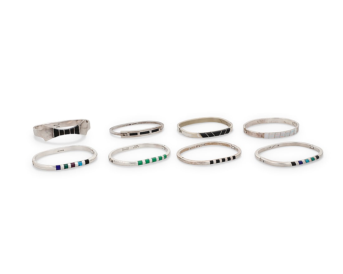 Eight Mexican silver and stone inlay bracelets: Eight Mexican silver and stone inlay bracelets Mid/late 20th century Each variously marked for Mexico; six marked for sterling A group of rectangular narrow silver bangles, each with hinged clasp, and
