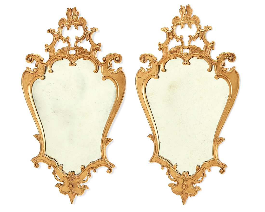 A pair of Louis XV style giltwood mirrors 20th century The frames each with scrollwork and foliate: A pair of Louis XV style giltwood mirrors 20th century The frames each with scrollwork and foliate accents 2 pieces Each: 47.25" H x 25.25" W x 2" D