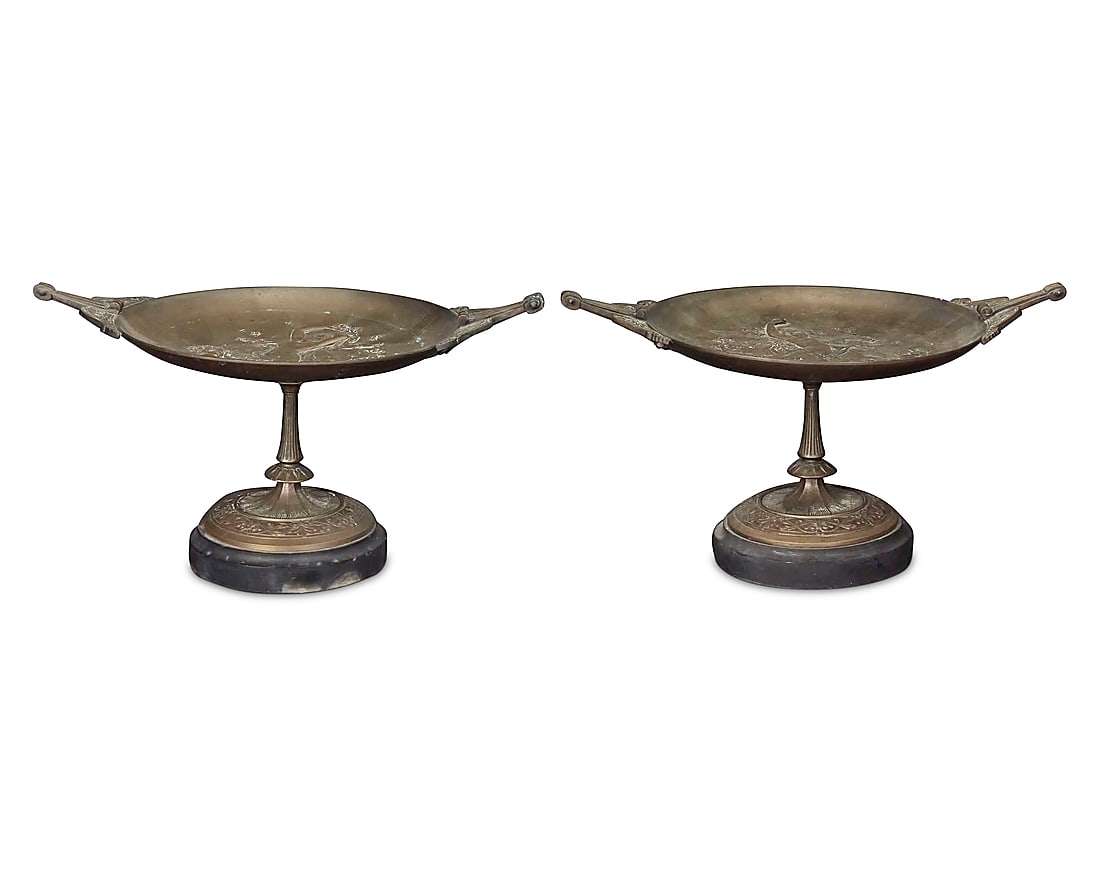 A pair of French patinated bronze tazzas Late 19th/early 20th century One with incised signature:: A pair of French patinated bronze tazzas Late 19th/early 20th century One with incised signature: SALMSON Each depicting a maiden in low relief at center of bowl, raised on a stone base 2 pieces Each: