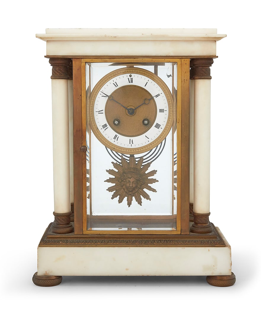 An Empire style marble mantel clock Early 20th century Impressed to movement: MEDAILLE D'OR /: An Empire style marble mantel clock Early 20th century Impressed to movement: MEDAILLE D'OR / Samuel Martí / Paris 1900 With twin-train movement striking on a gong, an enameled metal and parcel-gilt 
