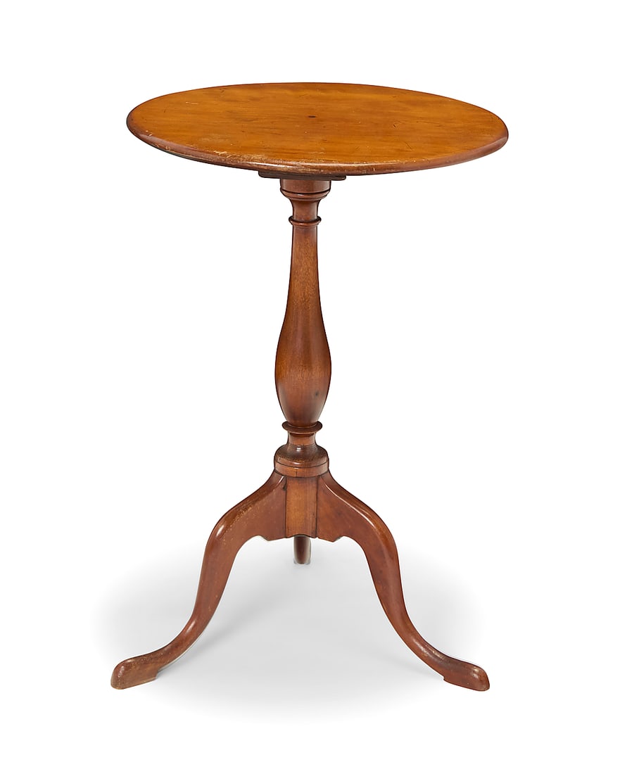 A Queen Anne mahogany tea table Mid-18th century The oval top raised on a turned standard and (1 of 6)