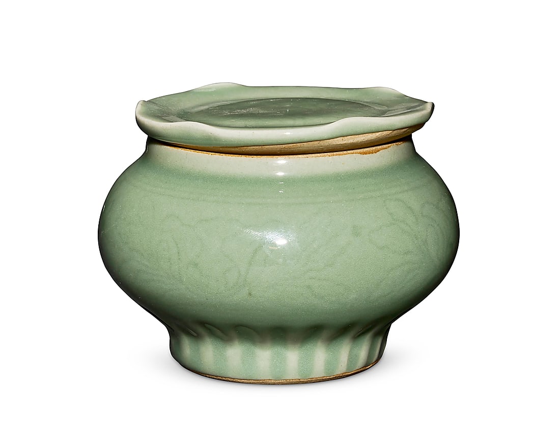 A Chinese Longquan celadon lidded jar Song/Yuan/Ming Dynasty (960-1644) or later With incised: A Chinese Longquan celadon lidded jar Song/Yuan/Ming Dynasty (960-1644) or later With incised floral motifs 3.875" H x 5.125" Dia.