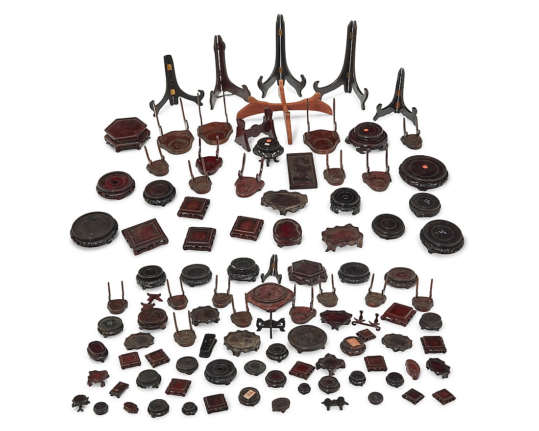 A large group of Asian hardwood stands 20th century Comprising various folding frame stands,: A large group of Asian hardwood stands 20th century Comprising various folding frame stands, Asian-style display bases, plate stands, and more Approximately 95 Various sizes and dimensions