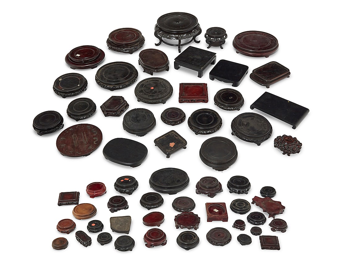 A large group of Asian hardwood stands 20th century Comprising various folding frame stands,: A large group of Asian hardwood stands 20th century Comprising various folding frame stands, Asian-style display bases, plate stands, and more Approximately 60 pieces Various sizes and dimensions