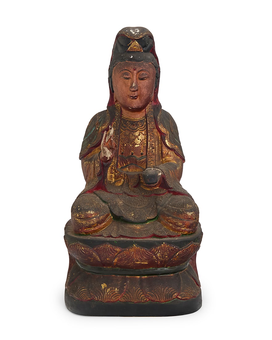 A Chinese polychrome carved wood figure of Guanyin 19th century Depicted seated on a double lotus: A Chinese polychrome carved wood figure of Guanyin 19th century Depicted seated on a double lotus base, with right hand in shunya mudra, parcel-gilt and painted, with inset glass accent to forehead 15