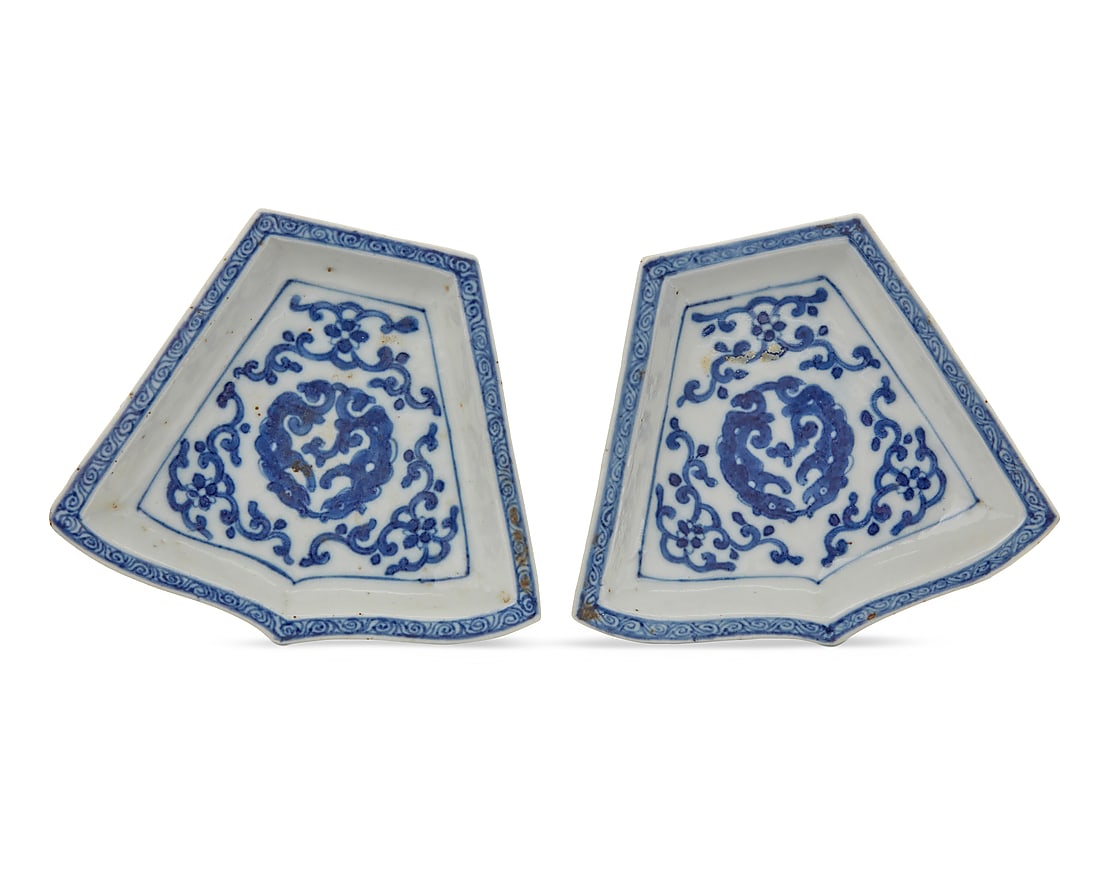A pair of Chinese blue and white porcelain sweet meat dishes: A pair of Chinese blue and white porcelain sweet meat dishes Qing Dynasty (1644-1912) or later Of trapezoidal form, decorated with beasts and scrolled motifs 2 pieces Each: 1" H x 5.375" W x 4.5" D