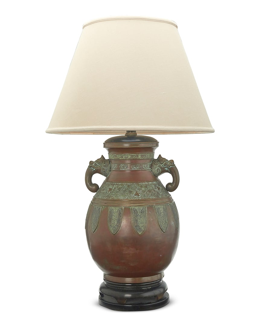 A Southeast Asian brass archaistic vessel mounted as a lamp Meiji/Taisho Period (1868-1926) Likely: A Southeast Asian brass archaistic vessel mounted as a lamp Meiji/Taisho Period (1868-1926) Likely Japanese, with opposed figural handles, banded meandering and ocean wave motifs, and fish to body, mo