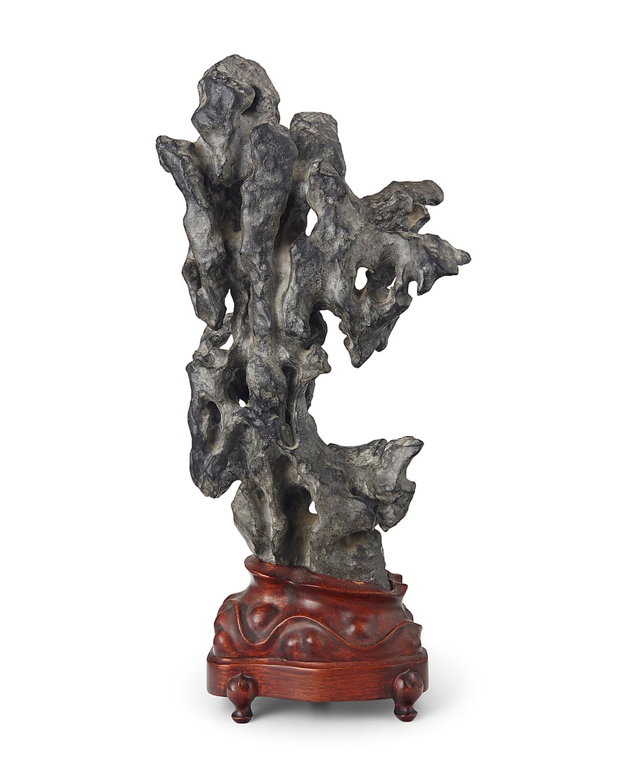 A Chinese Ling Bi scholar stone 20th century Mounted on a carved hardwood stand Stone: 13.75" H x: A Chinese Ling Bi scholar stone 20th century Mounted on a carved hardwood stand Stone: 13.75" H x 7.5" W x 4" D; Overall: 16.75" H