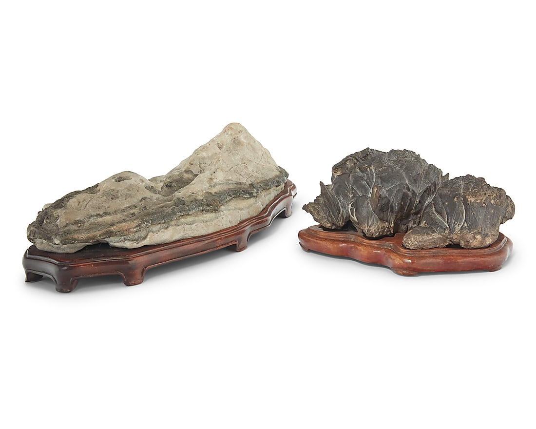 Two Chinese style scholar stones 20th century Each on a custom fitted wood base 2 pieces Larger: Two Chinese style scholar stones 20th century Each on a custom fitted wood base 2 pieces Larger overall: 4.75" H x 17.5" W x 8.5" D; Smaller overall: 4.25" H x 8.75" W x 7.125" D Provenance: Private c