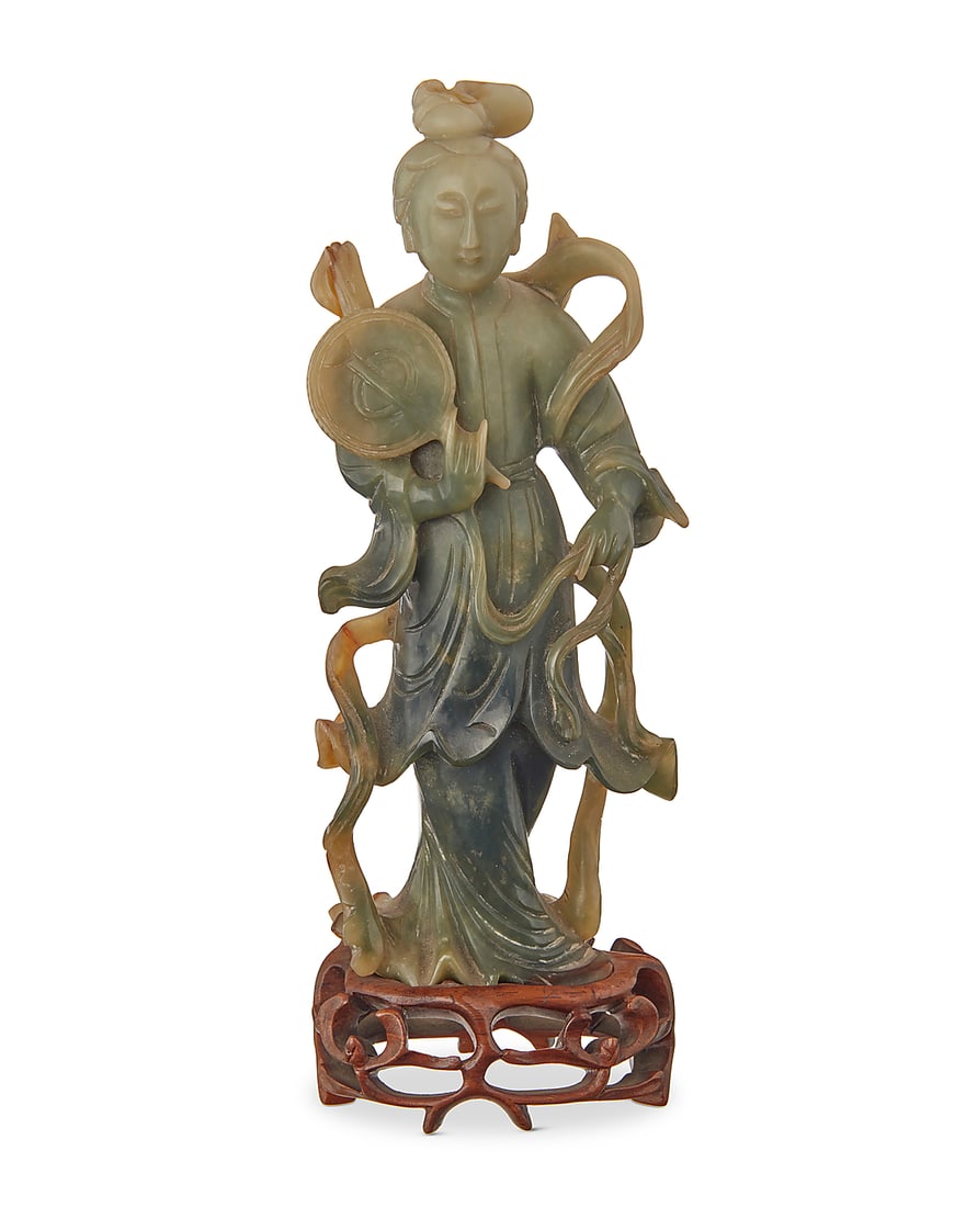 A Chinese jade carving of a beauty 20th century Raised on a carved hardwood stand Figure: 7.75" H: A Chinese jade carving of a beauty 20th century Raised on a carved hardwood stand Figure: 7.75" H x 3.125" W x 1.5" D; Overall: 8.625" H