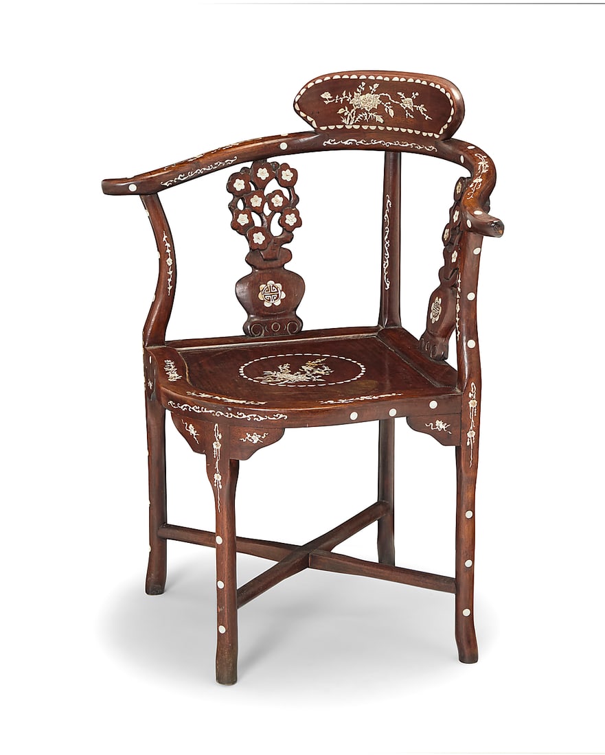 Y A Chinese inlaid carved rosewood corner chair 20th century With yolk back and mother-of-pearl: Y A Chinese inlaid carved rosewood corner chair 20th century With yolk back and mother-of-pearl floral motifs throughout, raised on four legs joined by an X-stretcher 32.75" H x 27.25" W x 21.75" D Th