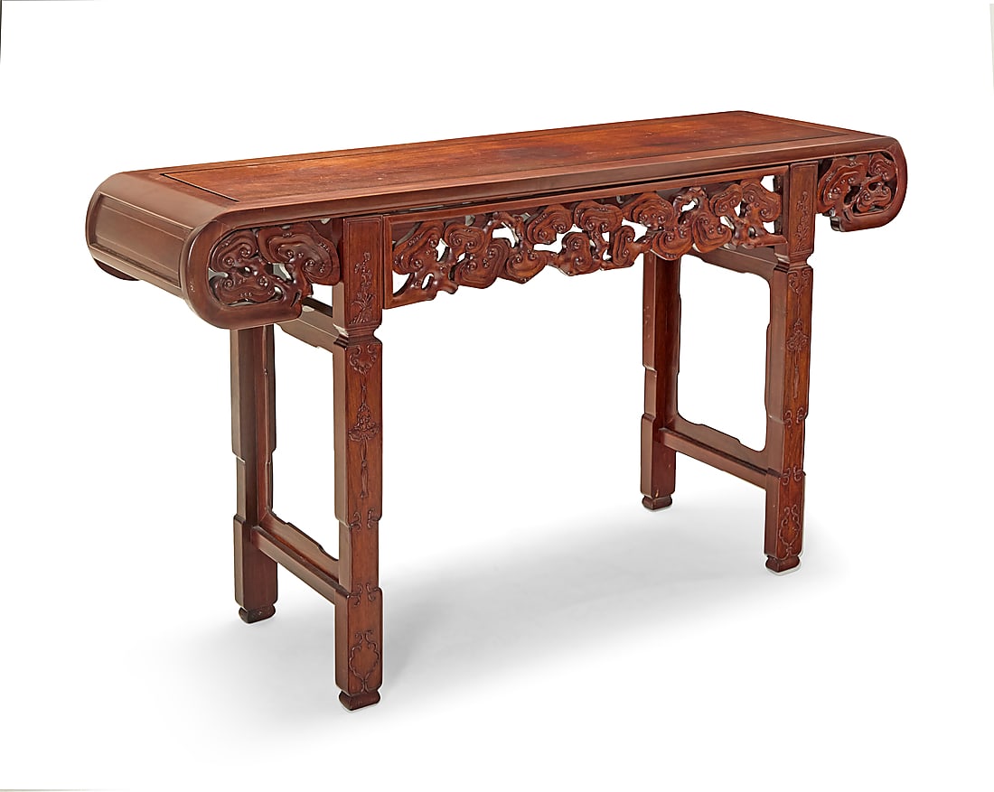 A Chinese carved hardwood altar table 20th century With rolled ends above pierced cloud motifs, (1 of 5)