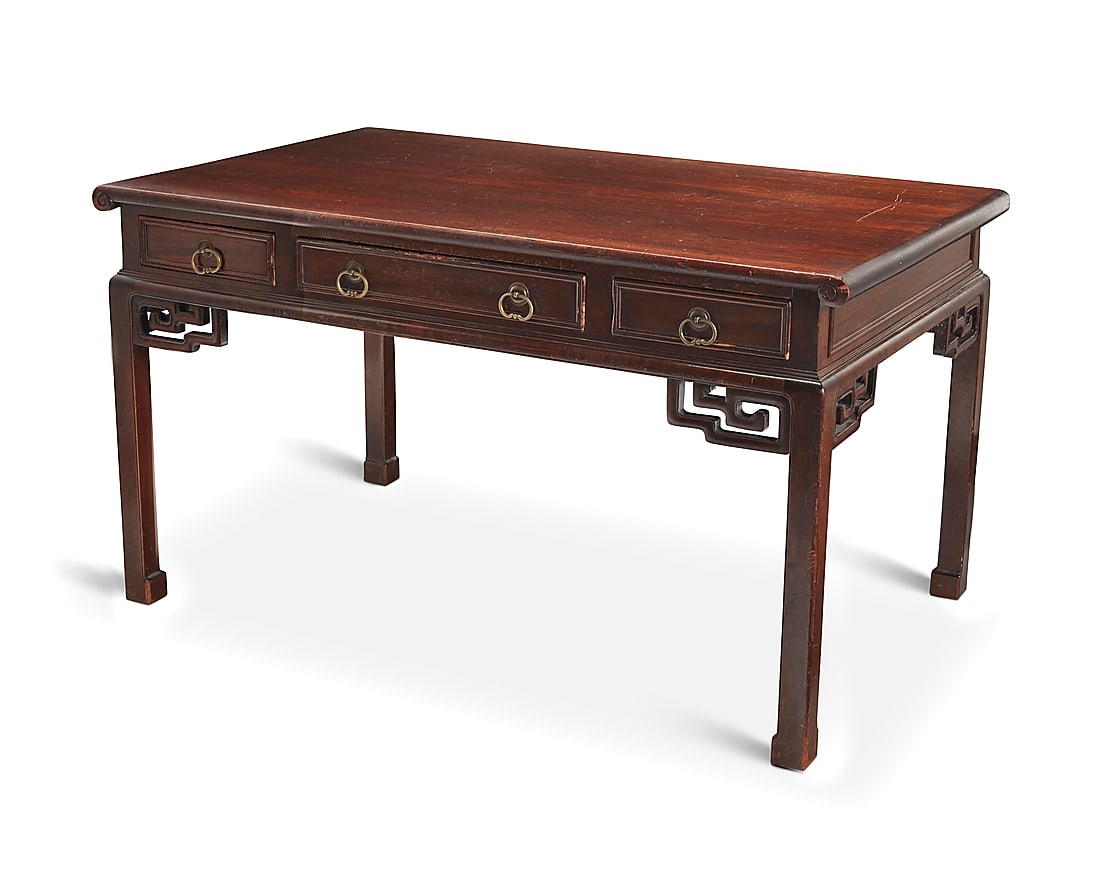 A Chinese carved wood writing table Early/mid-20th century With three drawers to one side and (1 of 5)