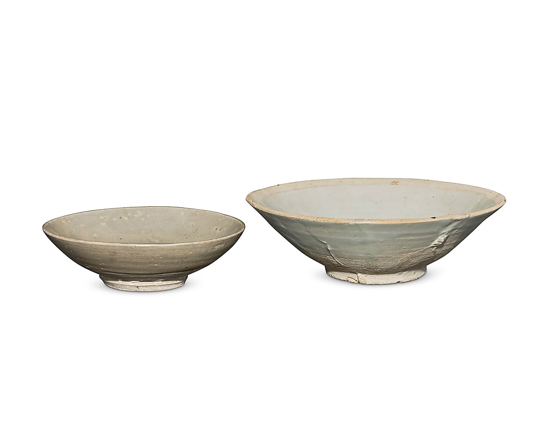 Two Southeast Asian celadon ceramic bowls 15th century or later Each with bisque foot 2 pieces: Two Southeast Asian celadon ceramic bowls 15th century or later Each with bisque foot 2 pieces Larger: 2.125" H x 6.875" Dia.; Smaller: 1.625" H x 5.25" Dia.