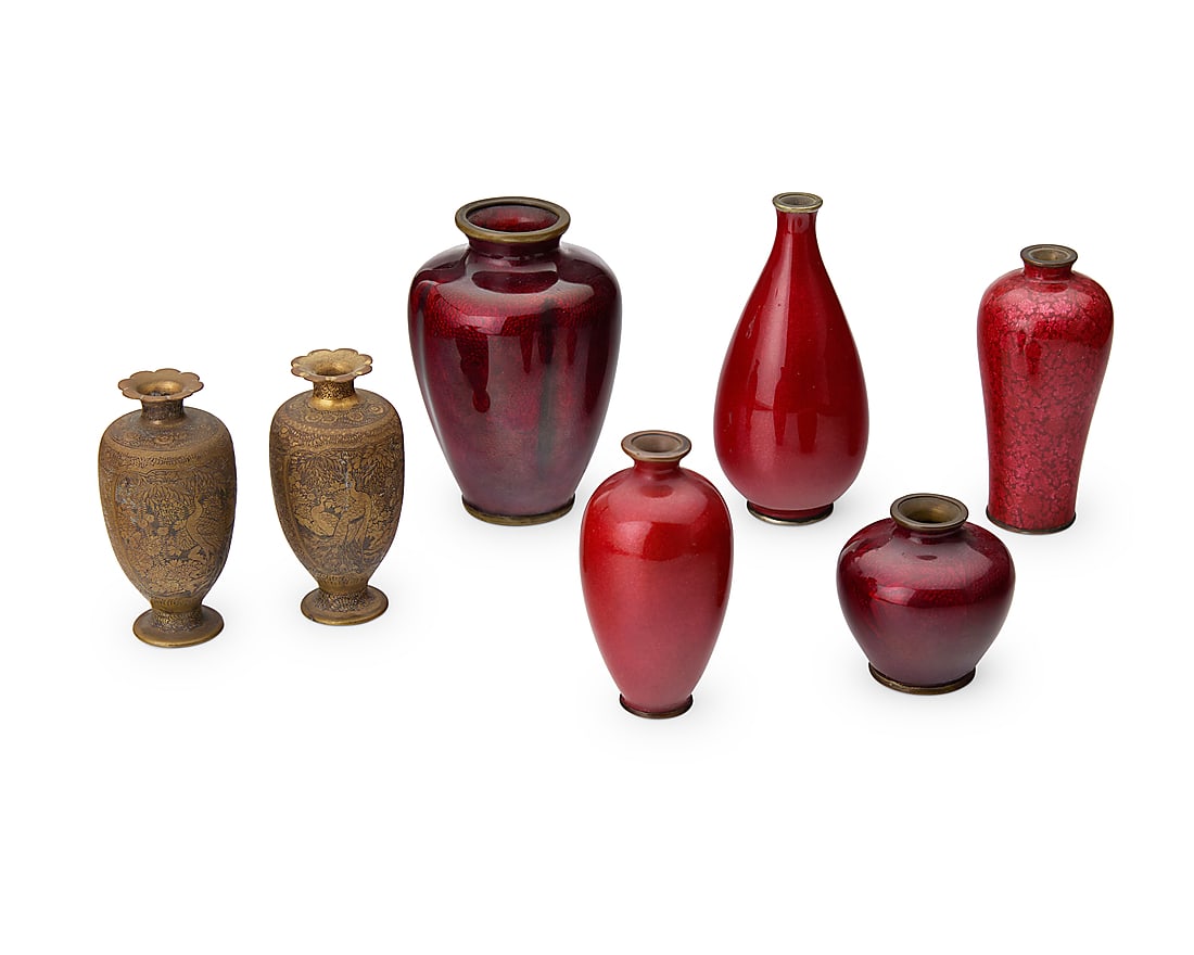 A group of seven East Asian diminutive bud vases 20th century One signed by Hayakawa Komejiro;: A group of seven East Asian diminutive bud vases 20th century One signed by Hayakawa Komejiro; others variously marked Comprising five red enamel vases and two bronze vases, each depicting a village s