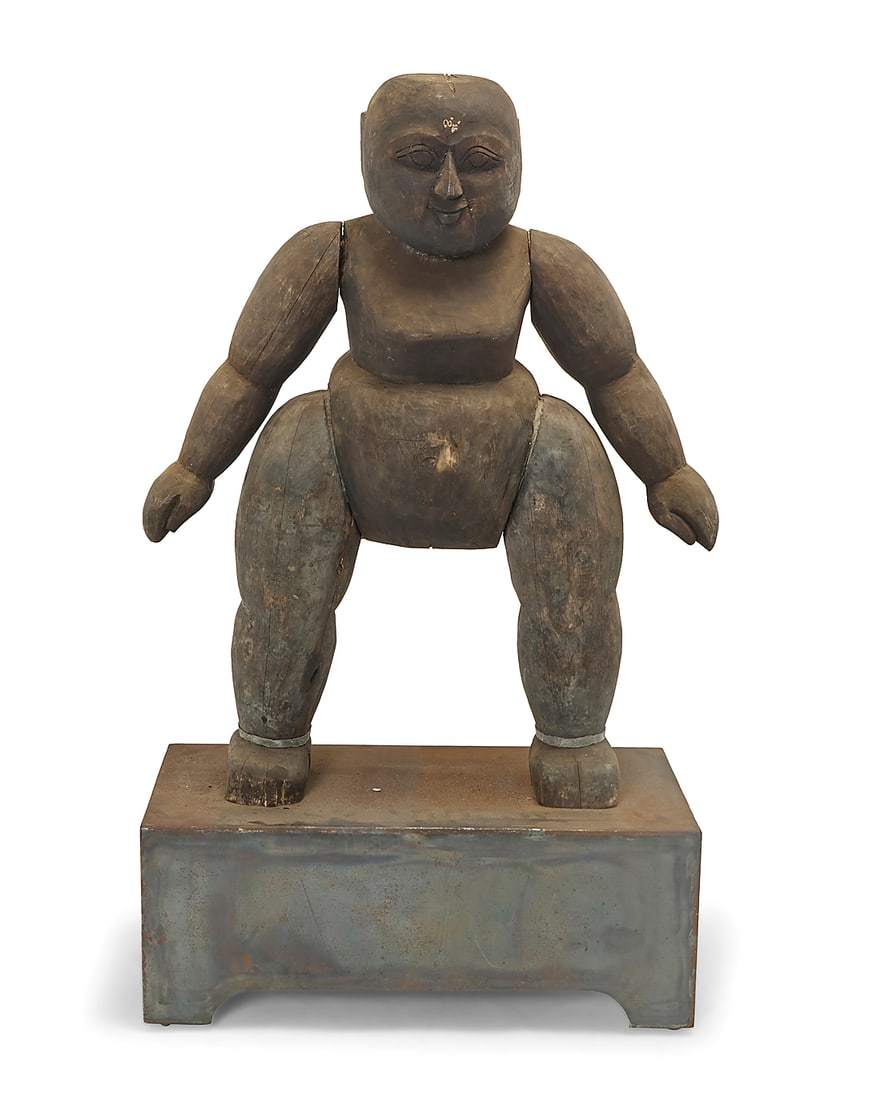 A carved wood guardian figure Likely Japanese, 20th century Depicting a stylized standing human: A carved wood guardian figure Likely Japanese, 20th century Depicting a stylized standing human form with simplified features Figure: 43" H x 34" W x 13" D; Plinth: 12.5" H x 32.25" W x 15.25" D Prove