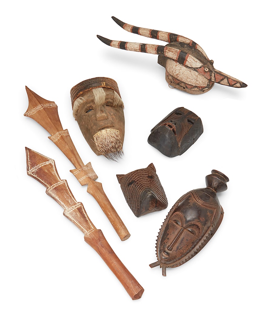 A group of seven carved wood masks and clubs (1 of 7)