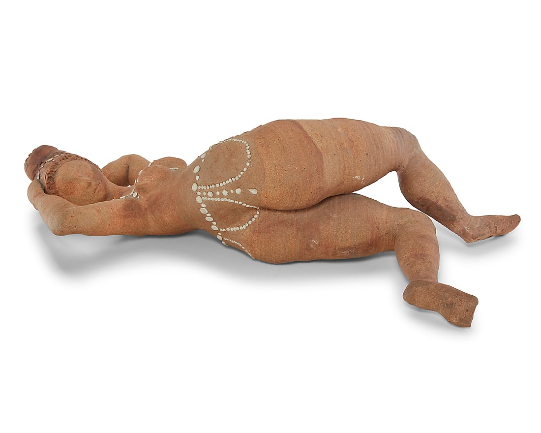 A terracotta studio pottery nude figure: A terracotta studio pottery nude figure Mid/late 20th century Faint incised signature from unknown artist to leg With partially glazed accents 6.75" H x 22.5" W x 10.5" D Provenance: Selections from