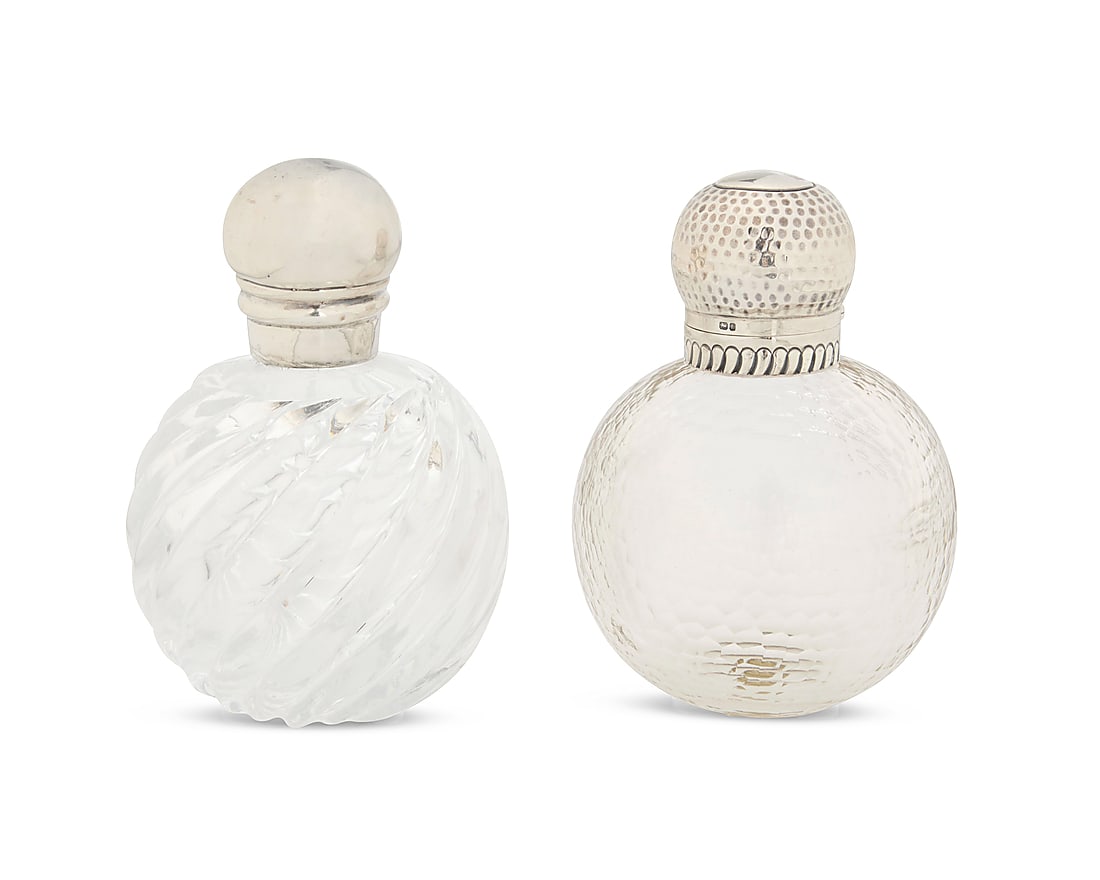 Two Victorian glass and sterling silver perfume bottles: Two Victorian glass and sterling silver perfume bottles Late 19th century Each lid marked for sterling; the hammered top marked for Chester, 1894, and maker: WA [William Aitken]; smooth marked for
