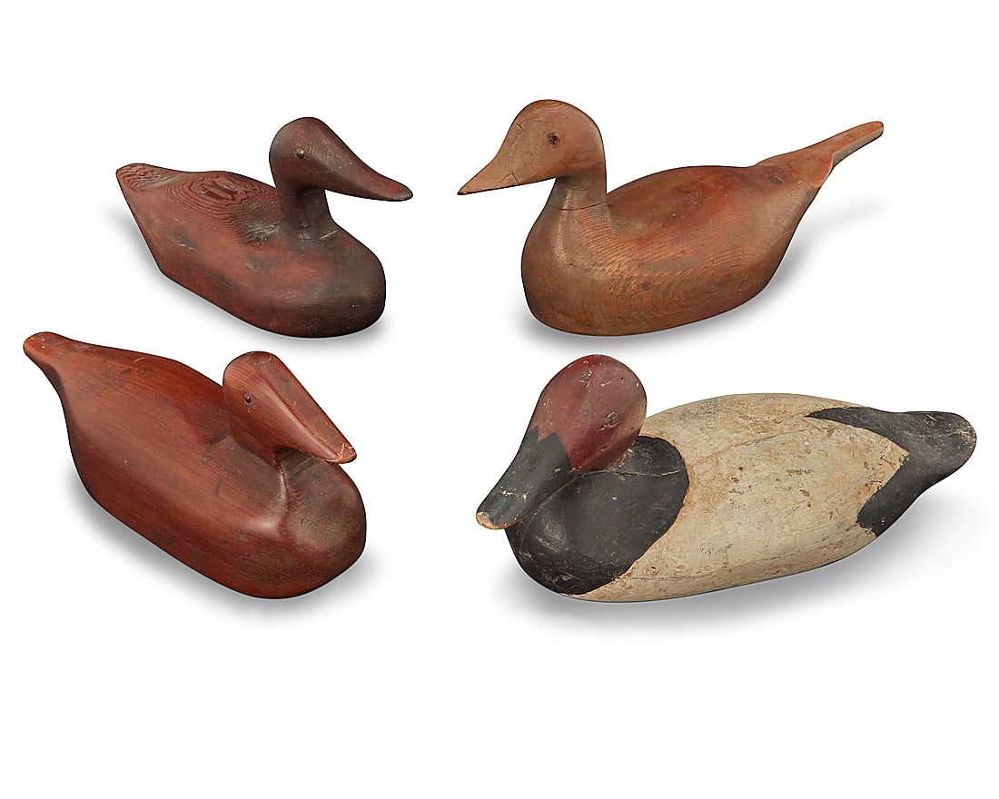 Four carved wood duck decoys: Four carved wood duck decoys 20th century One painted black and white 4 pieces Largest: 7.375" H x 20.75" W x 6" D; Smallest: 5.5" H x 12.375" W x 3.75" D Provenance: The Grace Family Collection, St.