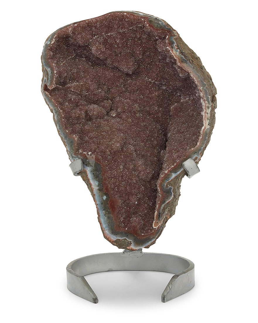 A druzy agate geode specimen: A druzy agate geode specimen 20th century; Uruguay On a custom enameled metal display stand Specimen: 14.75" H x 11" W x 6" D; Stand: 11.5" H x 8.375" W x 7.25" D Provenance: Sold: Bonhams, Los Angele