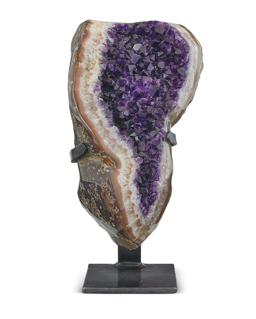An amethyst geode specimen: An amethyst geode specimen 20th century On a metal stand Geode: 12" H x 7" W x 4" D; Stand: 8.5" H x 5.75" W x 4" D