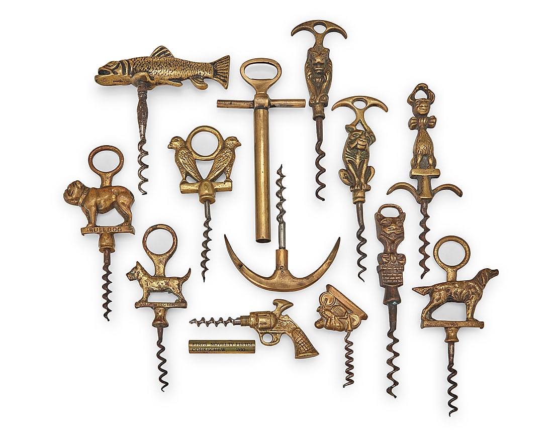 A group of brass figural corkscrews: A group of brass figural corkscrews Late 19th/early 20th century Comprising one anchor, one pistol, four dogs, one motorcyclist, one fish, one bird group, and three other animals 12 pieces Largest: 6.