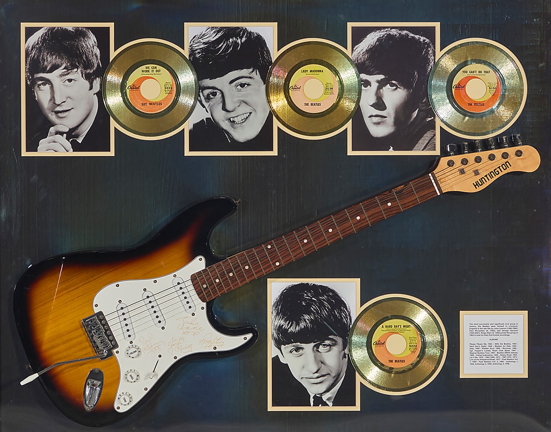 A framed collection of Beatles memorabilia: A framed collection of Beatles memorabilia Late 20th century Comprising a replica guitar with etched representations of signatures from the four members of the Beatles, as well as photographic prints