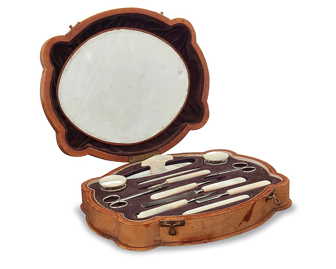 A vintage Casa Escasany manicure grooming set: A vintage Casa Escasany manicure grooming set Early/mid-20th century Label to base: Casa Escasany; impressed stamp to base: Made in Austria The large shaped wooden case covered in tan leather with gil