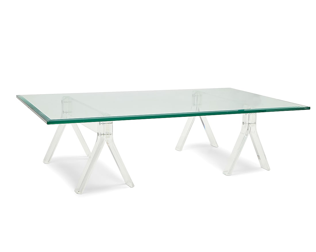 A Modern glass and acrylic coffee table: A Modern glass and acrylic coffee table Late 20th century The beveled glass top raised on two sawhorse-form acrylic supports 3 pieces Each support: 15.125" H x 28.125" W x 12.5" D; Glass: 60" W x 36"