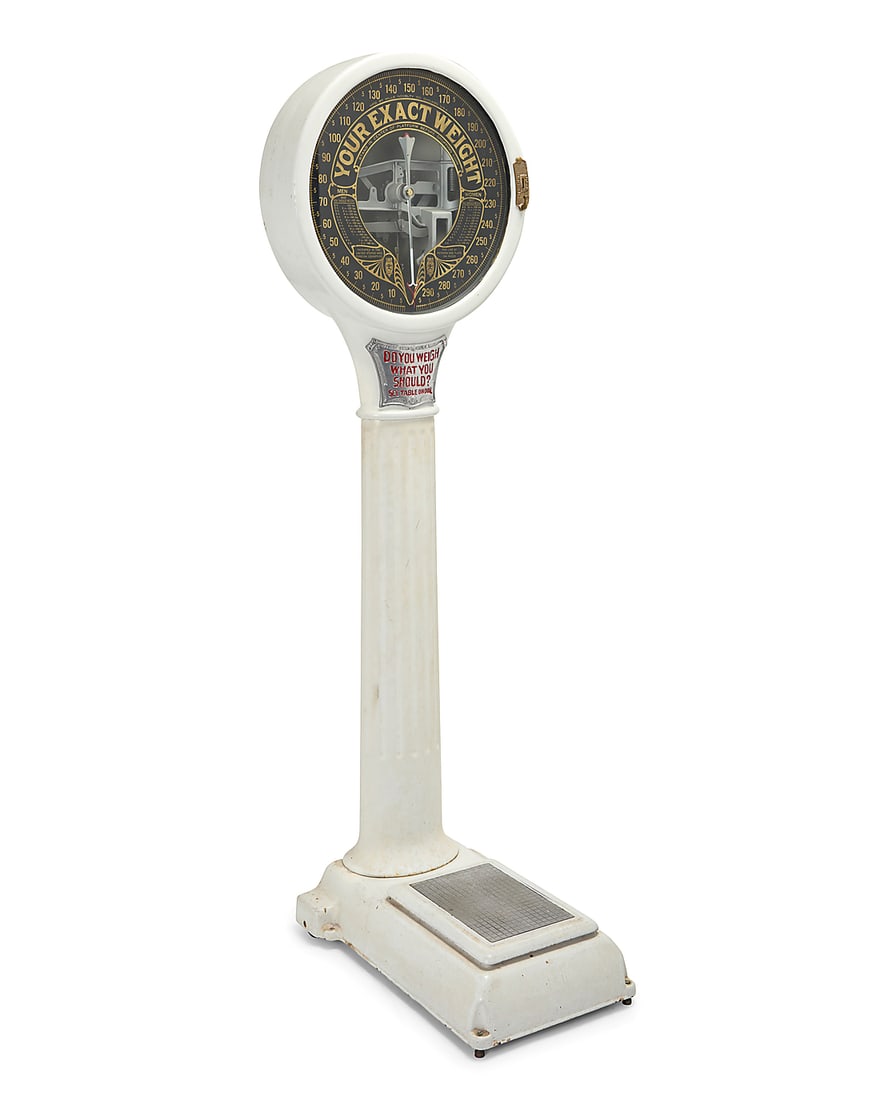 A Mills Novelty Co. lollipop coin op scale: A Mills Novelty Co. lollipop coin op scale 1920s With factory metal plate applied to interior of dial White painted porcelain over iron, with glazed dial reading 'YOUR EXACT WEIGHT', raised on a colum