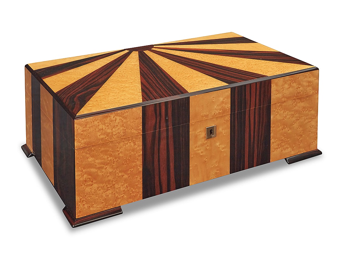 A Dunhill 'Starburst' humidor: A Dunhill 'Starburst' humidor Early 21st century Marked for Dunhill to interior Macassar ebony and burlwood veneer Height 6 3/8 in., width 18 in., depth 11 1/8 in.