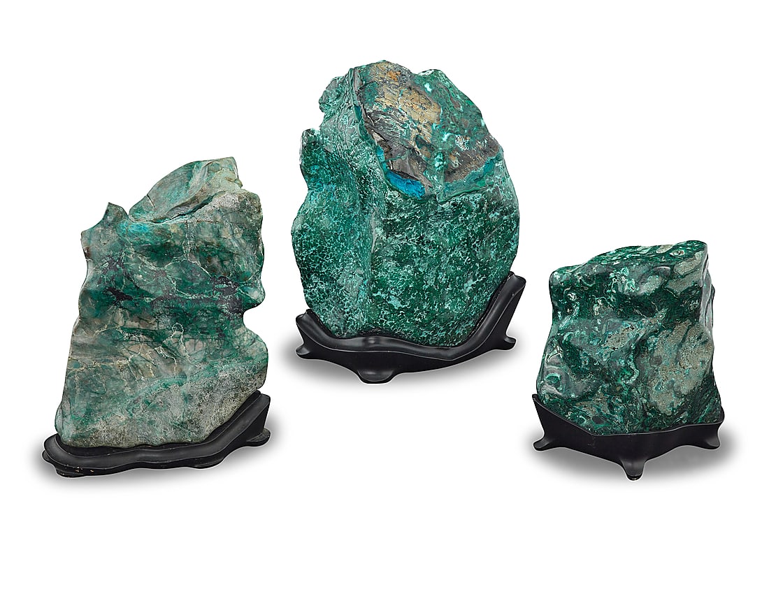 Three polished malachite specimens: Three polished malachite specimens Democratic Republic of the Congo Each exhibiting patterns of overgrowth, raised on a custom-fitted black stand 3 pieces Tallest overall height 11 1/2 in., width 9