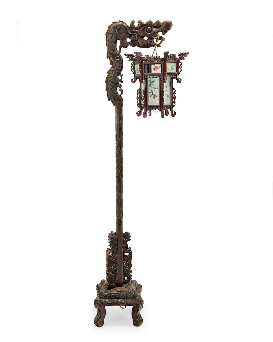 A Chinese carved wood and painted glass lantern: A Chinese carved wood and painted glass lantern 20th century Comprising a dragon-form cantilever stand carved with cloud accents, married to a later carved wood and interior-painted glass lantern
