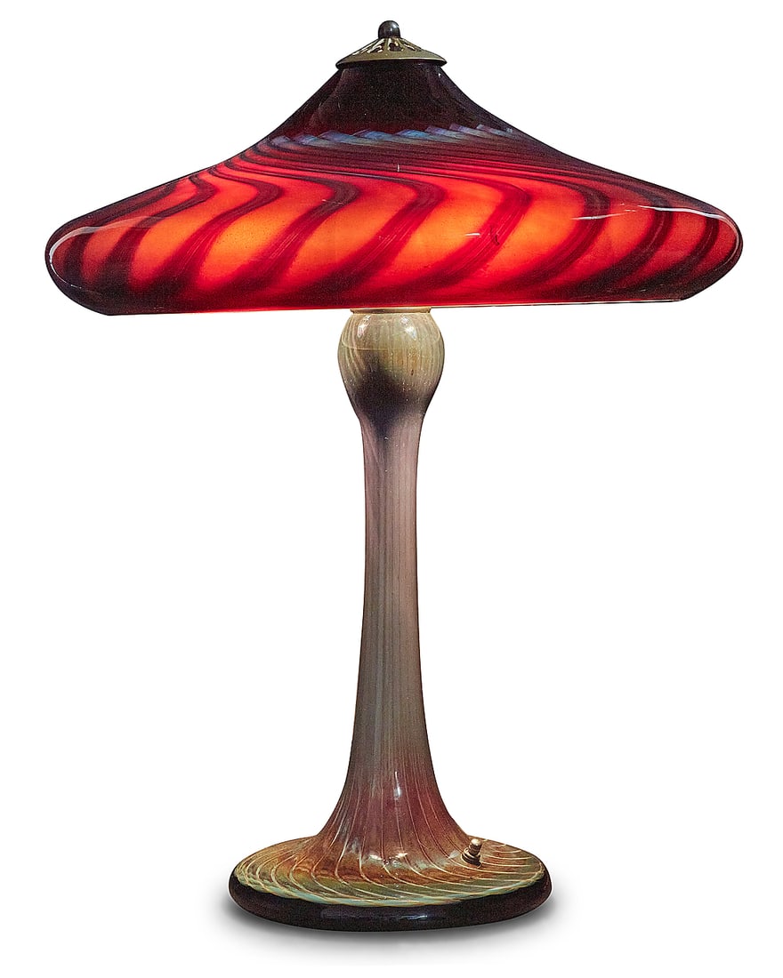 Joe Clearman (b. 1946), An art glass lamp, 1991: Joe Clearman (b. 1946) An art glass lamp, 1991 Base etched with signature, date, and number: J Clearman / 2499 / 2594 The glass base issuing three lights with brass heat cap, surmounted by a swirling