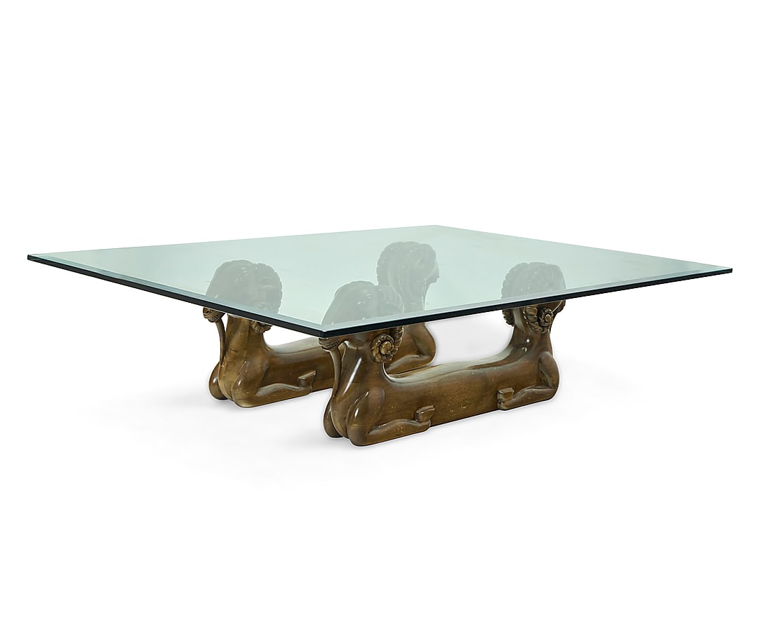 A Modern carved wood and glass figural coffee table: A Modern carved wood and glass figural coffee table Circa 1975 The beveled edge glass top over a base in the form of two pairs of conjoined rams 3 pieces Glass length, 68 1/4 in., width 48 1/4 in.; ea