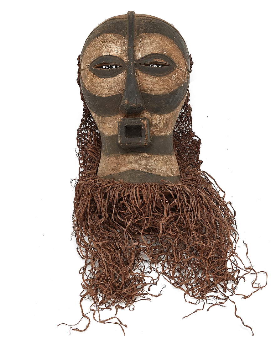 An African Kifwebe carved wood mask: An African Kifwebe carved wood mask 20th century, Luba or Songye; Democratic Republic of the Congo Pigmented wood with applied woven fibrous backing and fringe Overall height 26 in., width 15 in., dep