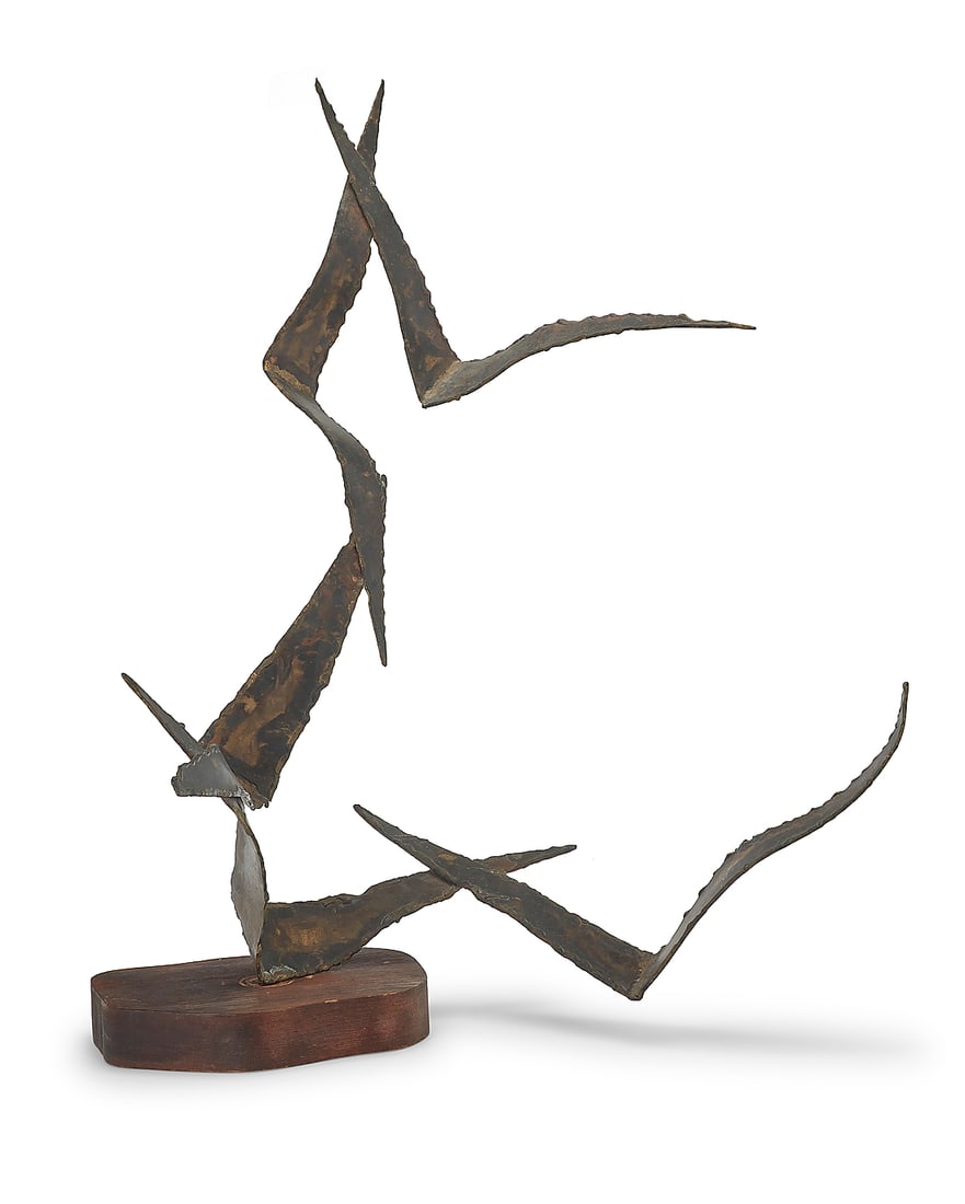 A Curtis Jere style metal sculpture: A Curtis Jere style metal sculpture Late 20th century Unmarked Depicting five birds in flight, raised on a wood base Overall height 32 in., width 24 1/2 in., depth 15 1/2 in. approximately